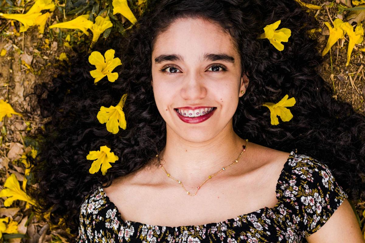 Young woman smiling with metal braces